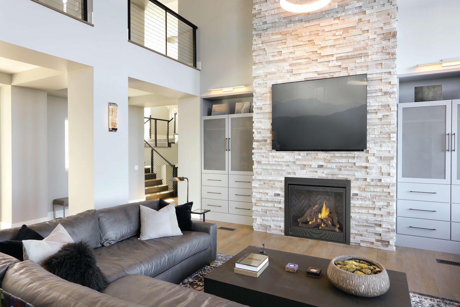 a direct vent gas fireplace with a brick mantle and tv above it