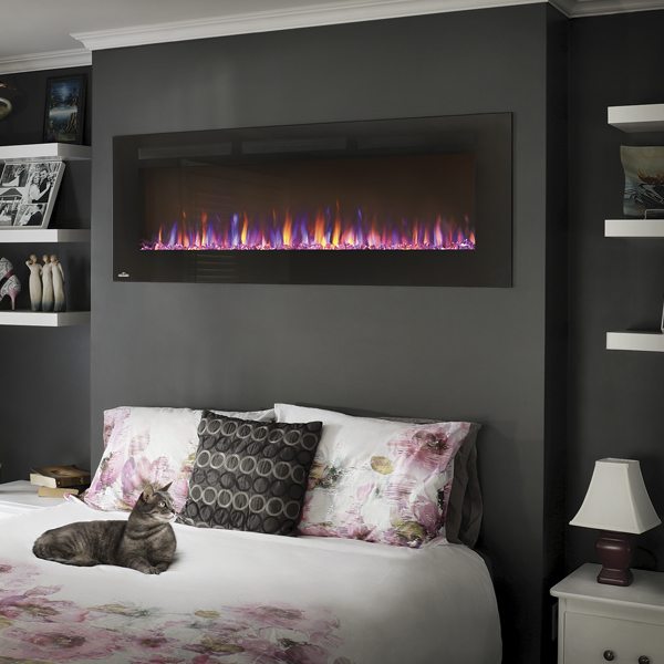 A wall hanging electric fireplace adds warm ambiance to a winter night
