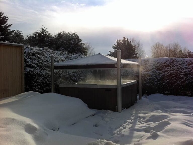 A hot tub with a Covana cover in the snow