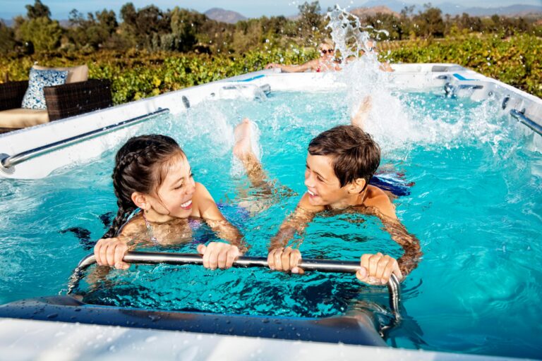 children learning to swim in a swim spa