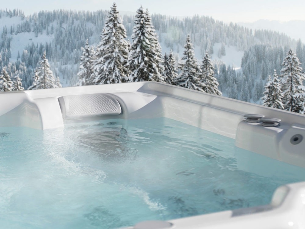 hot tub with a view of winter forest