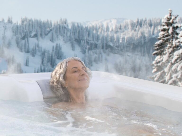 a woman relaxing in hot tub in winter